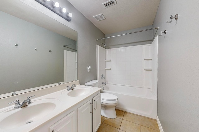 full bathroom with vanity, toilet, tub / shower combination, a textured ceiling, and tile patterned flooring