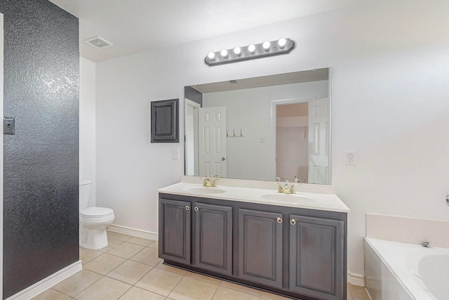 bathroom featuring vanity, tile patterned flooring, toilet, and a bath