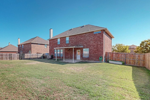 back of property with a lawn, a patio area, and central AC