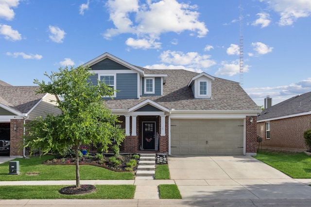 craftsman-style house with a front yard, a garage, and central AC unit