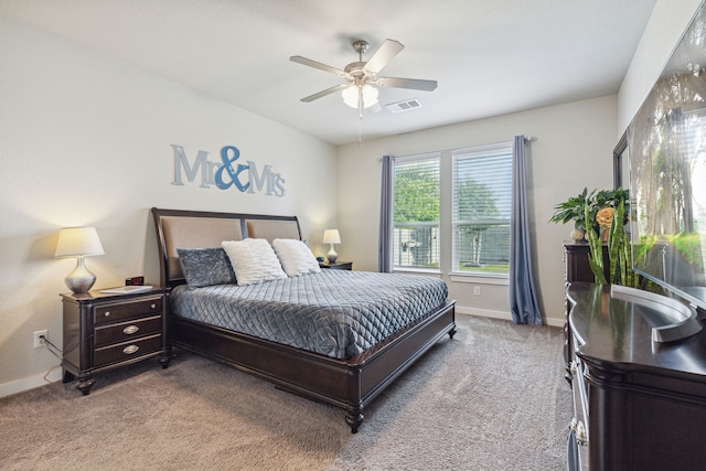 bedroom with ceiling fan and light colored carpet