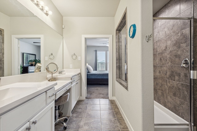 bathroom with tile patterned floors, a shower with door, and vanity