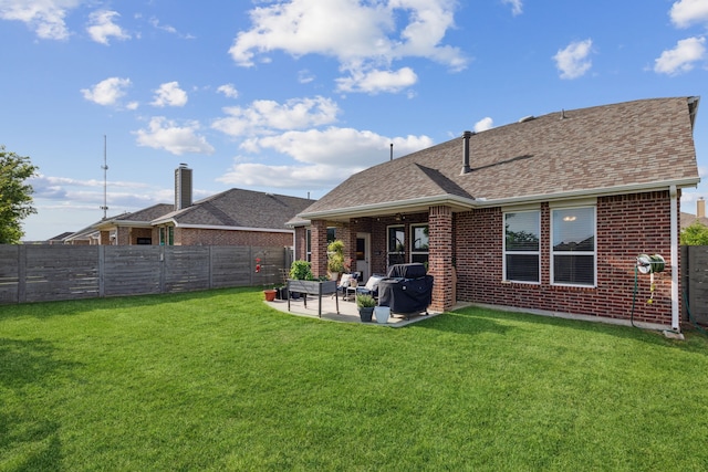 rear view of property featuring a patio area and a lawn