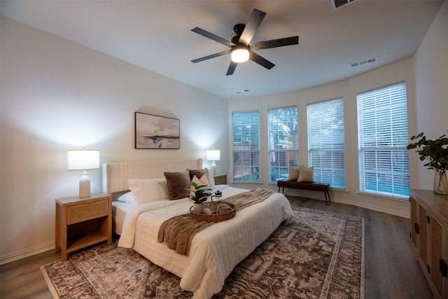 bedroom with ceiling fan and dark hardwood / wood-style flooring