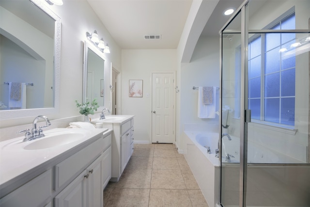 bathroom featuring plus walk in shower, tile patterned floors, and vanity