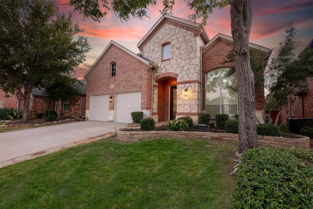 front facade with a yard and a garage