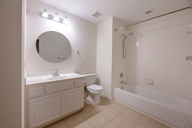 full bathroom featuring tiled shower / bath, vanity, toilet, and tile patterned floors