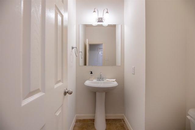 bathroom with tile patterned flooring and toilet