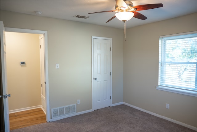 unfurnished bedroom featuring carpet floors and ceiling fan