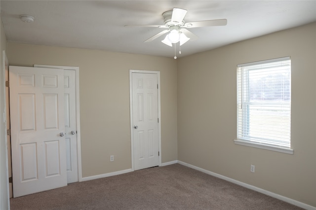 unfurnished bedroom featuring carpet and ceiling fan