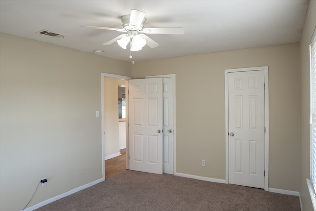 unfurnished bedroom featuring carpet floors and ceiling fan