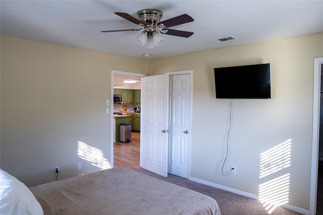 bedroom with carpet, ceiling fan, and a closet