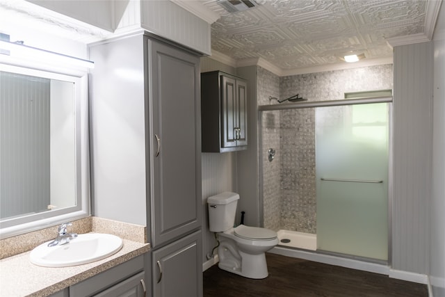 bathroom with an enclosed shower, hardwood / wood-style floors, and crown molding