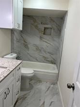 full bathroom featuring vanity, toilet, and shower / washtub combination