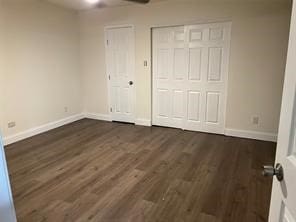 unfurnished bedroom featuring dark wood-type flooring