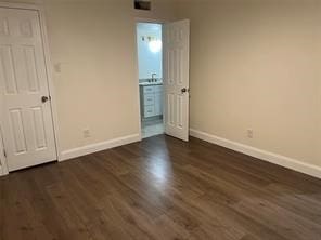 unfurnished bedroom featuring dark hardwood / wood-style floors