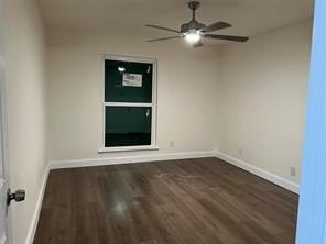 empty room featuring dark hardwood / wood-style floors and ceiling fan