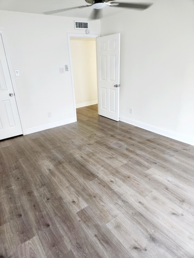 empty room featuring hardwood / wood-style floors and ceiling fan