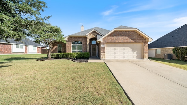 view of front of home with central AC unit, a garage, and a front lawn