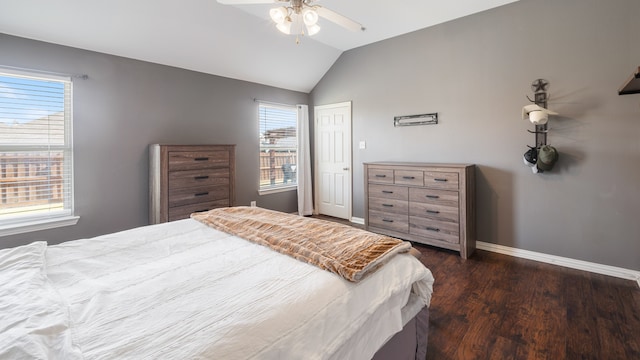 bedroom featuring multiple windows, vaulted ceiling, dark hardwood / wood-style flooring, and ceiling fan