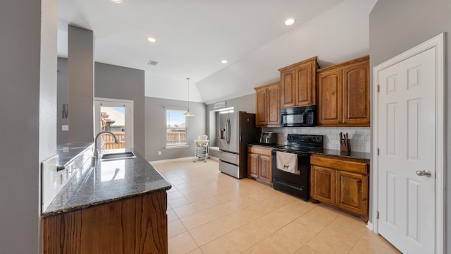 kitchen featuring vaulted ceiling, backsplash, light tile patterned floors, black appliances, and sink