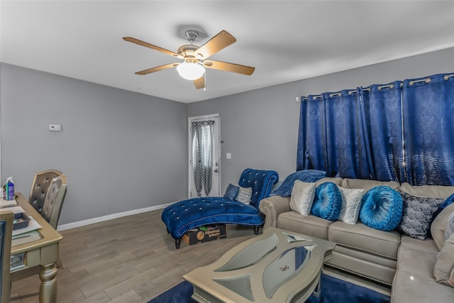 living room featuring wood-type flooring and ceiling fan