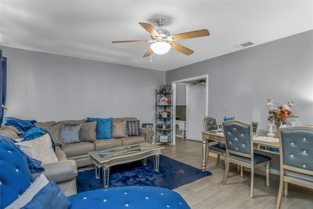 living room featuring wood-type flooring and ceiling fan