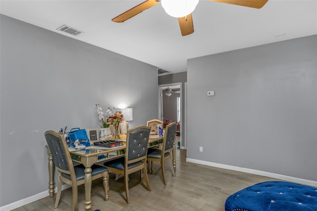 dining space with light hardwood / wood-style floors and ceiling fan