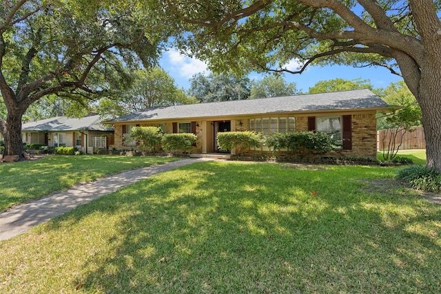 ranch-style home with a front lawn