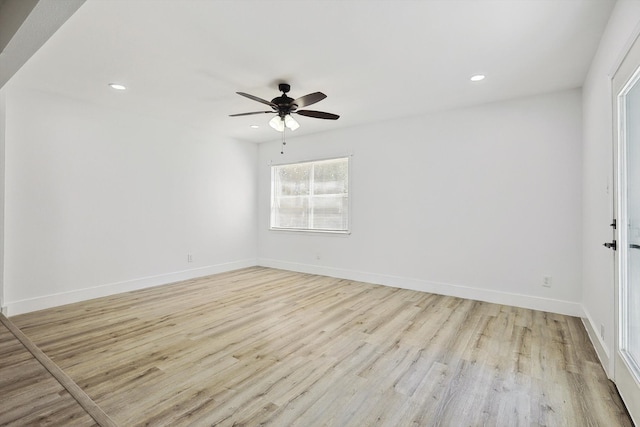 empty room featuring light wood-type flooring and ceiling fan