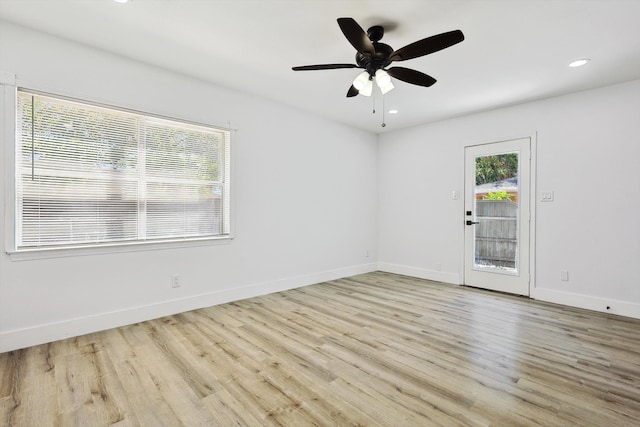 spare room featuring light hardwood / wood-style floors and ceiling fan