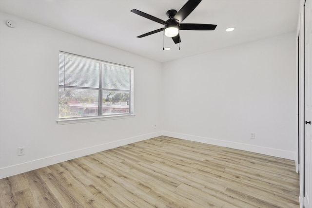 spare room with light hardwood / wood-style floors and ceiling fan