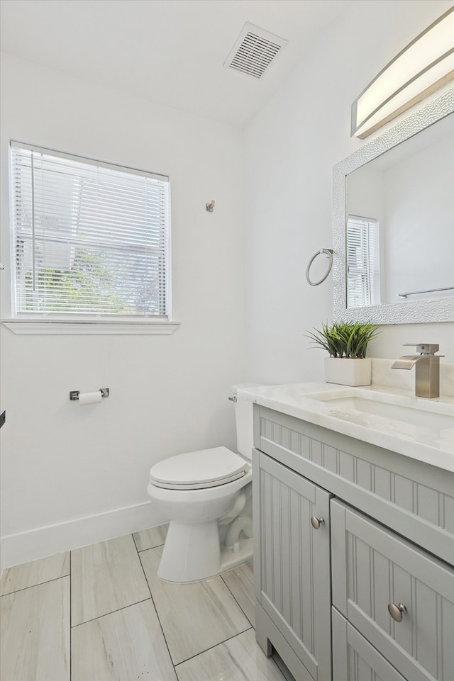 bathroom featuring vanity and toilet