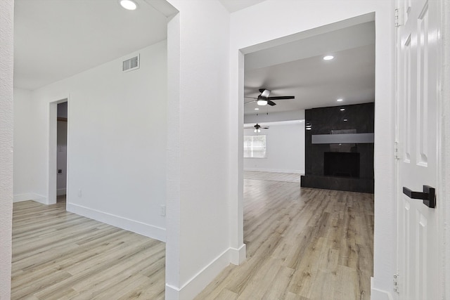 hallway with light hardwood / wood-style floors