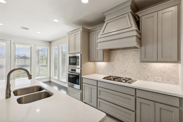 3705 Birch Wood Ct, Northlake, TX 76226 - kitchen with visible vents, gray cabinets, custom range hood, a sink, and stainless steel appliances