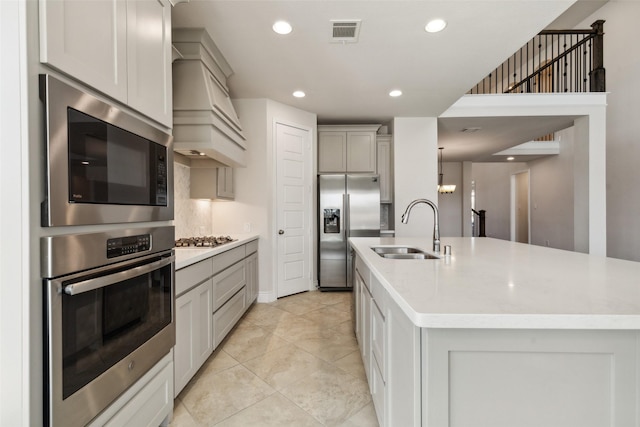 3705 Birch Wood Ct, Northlake, TX 76226 - kitchen with visible vents, custom exhaust hood, a sink, gray cabinetry, and stainless steel appliances