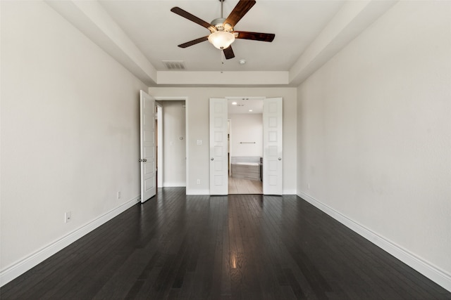 unfurnished bedroom with ensuite bath, ceiling fan, and dark hardwood / wood-style floors