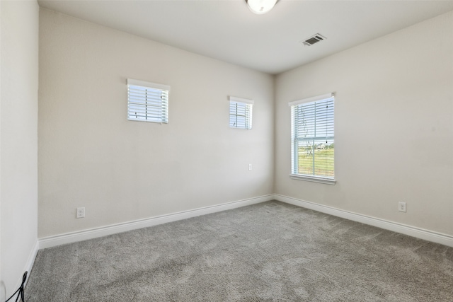 carpeted empty room featuring plenty of natural light