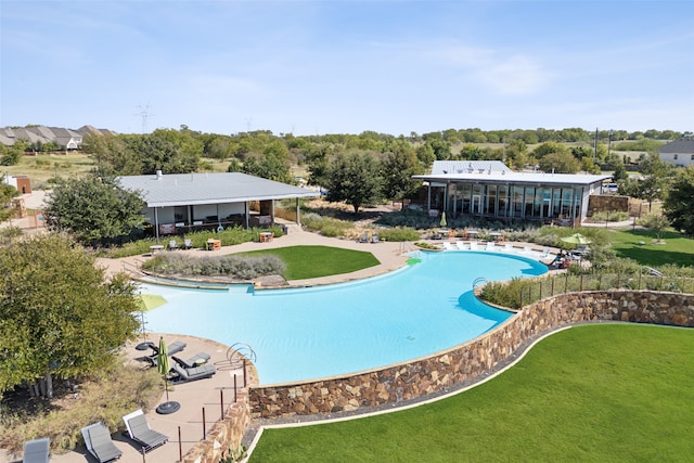 view of swimming pool with a yard and a patio area