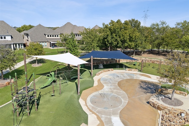 view of home's community featuring a playground and a yard