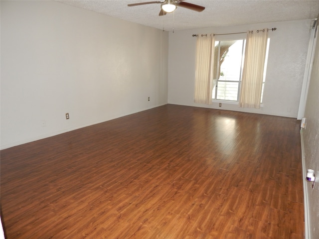 unfurnished room with ceiling fan, a textured ceiling, and dark hardwood / wood-style flooring