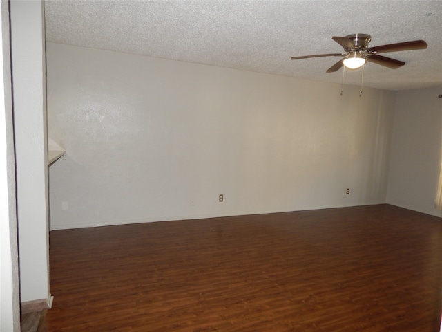 unfurnished room featuring a textured ceiling, dark hardwood / wood-style floors, and ceiling fan