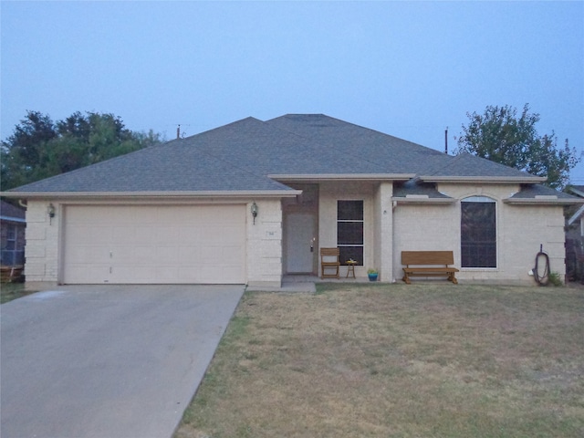 single story home featuring a front yard and a garage