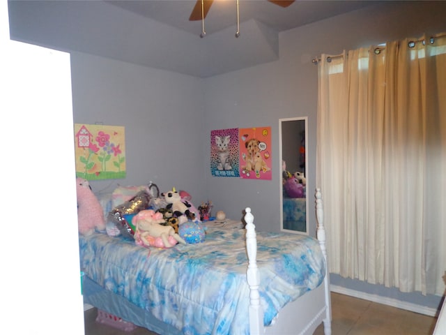 tiled bedroom featuring ceiling fan