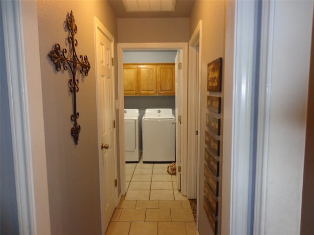 washroom with cabinets, light tile patterned floors, and washer and dryer