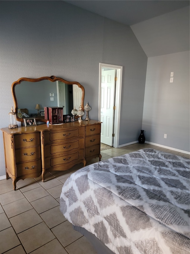 tiled bedroom with lofted ceiling