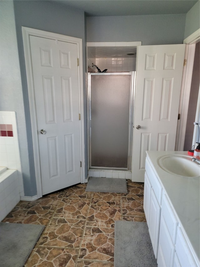 bathroom featuring independent shower and bath and vanity