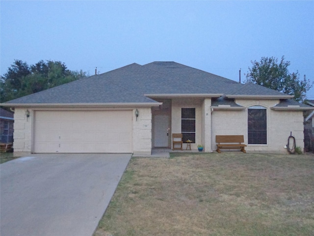 ranch-style home with a garage and a front yard