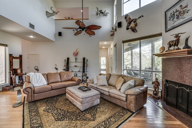 bedroom featuring ceiling fan, light hardwood / wood-style floors, and multiple windows