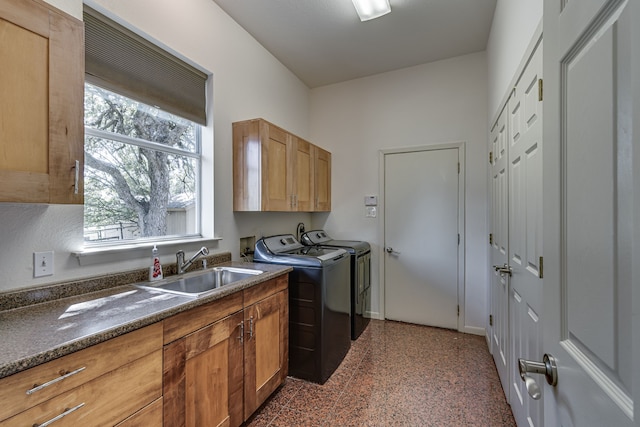 laundry area with a healthy amount of sunlight, independent washer and dryer, sink, and cabinets